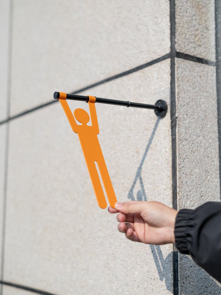 Hanging restroom sign silhouette being placed on the rod
