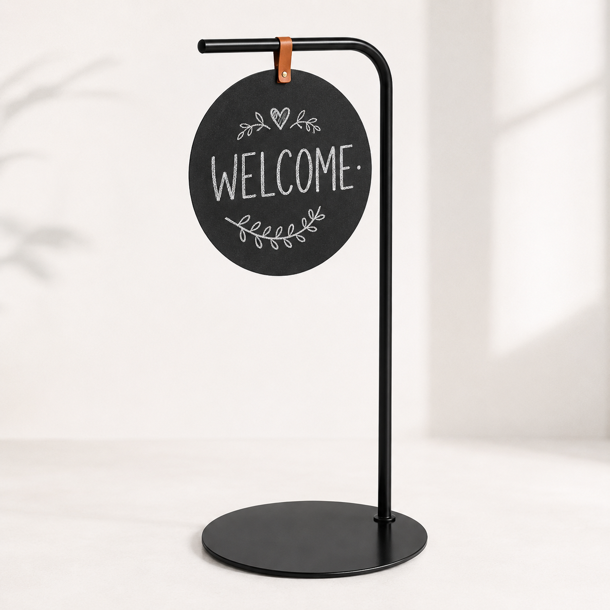 Black curved-tube chalkboard-style message stand with round board